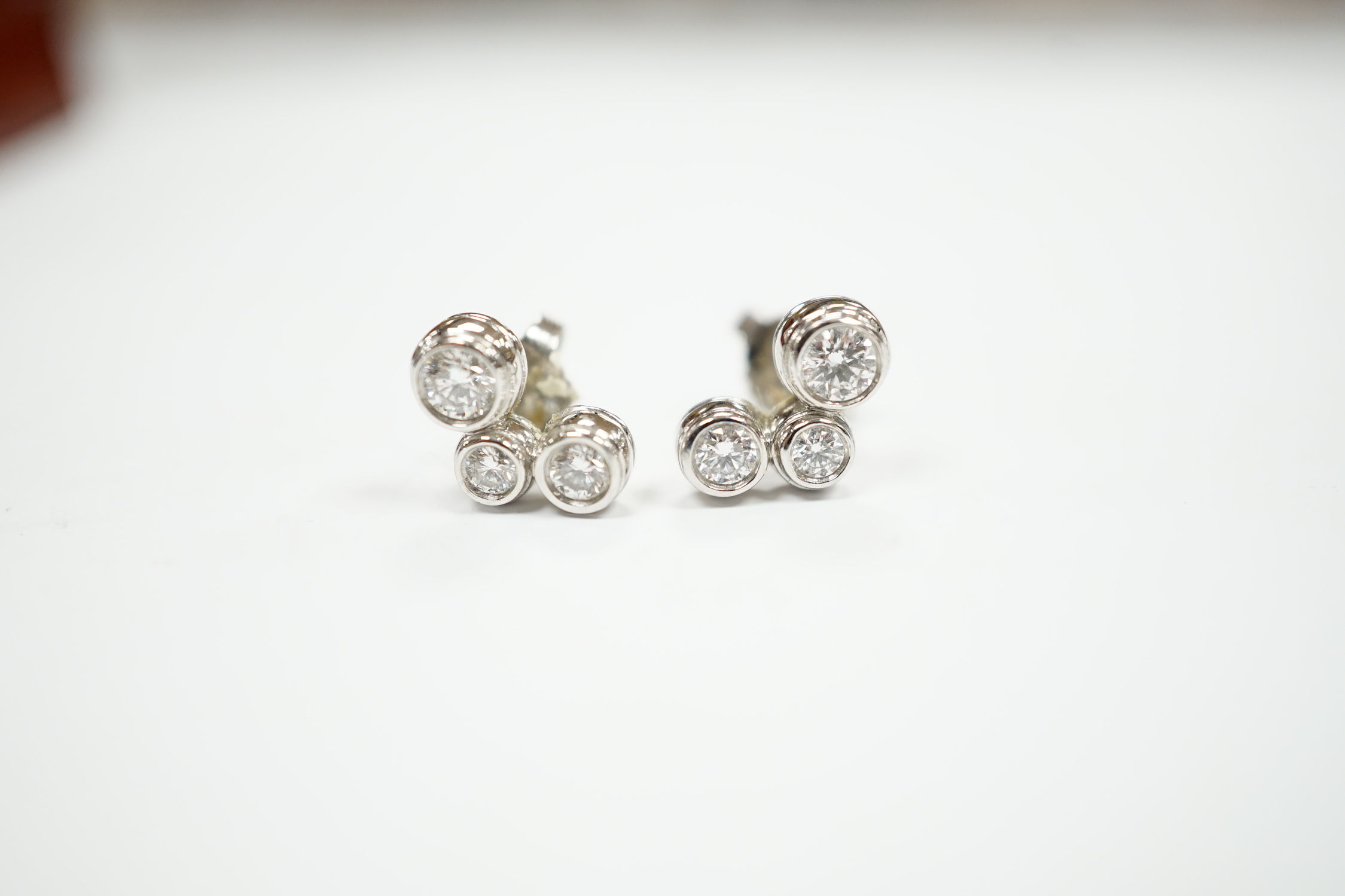 A modern pair of Tiffany & Co platinum and three stone graduated diamond set ear studs, 10mm, gross weight 4.1 grams.